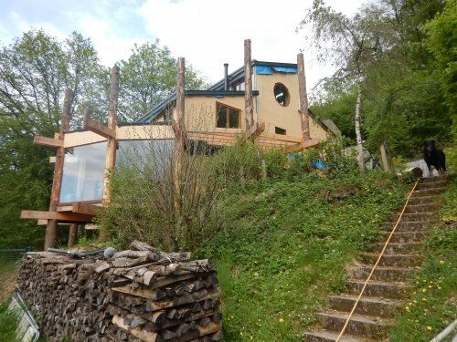Réhabilitation et isolation en paille  par l'extérieur d’une maison en brique et bloc béton 
