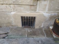 Rejointoiement à la chaux d'un mur enduit au ciment dans une cage d'escalier